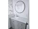 Bathroom with a stylish sink, vanity and round mirror at 5860 Sw 64Th Street Rd, Ocala, FL 34474