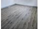 A bedroom featuring gray wood-look flooring and neutral wall paint at 5860 Sw 64Th Street Rd, Ocala, FL 34474