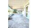 Covered outdoor patio with views to the green backyard and trees at 5860 Sw 64Th Street Rd, Ocala, FL 34474