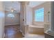 Bright bathroom featuring a large soaking tub with a large window at 5916 Nw 27Th Pl, Ocala, FL 34482