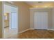 Bedroom with tile floors and access to the bathroom and double closet at 5916 Nw 27Th Pl, Ocala, FL 34482