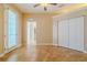 Bedroom with tile floors, a ceiling fan, double closets, and access to the bathroom at 5916 Nw 27Th Pl, Ocala, FL 34482