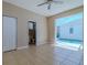 This bedroom features a walk-in closet, access to the bathroom, and sliding glass doors leading to the pool at 5916 Nw 27Th Pl, Ocala, FL 34482