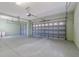 This garage features a windowed garage door, epoxy floors, and a side-entry door at 5916 Nw 27Th Pl, Ocala, FL 34482