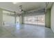 This garage features a windowed garage door, epoxy floors, and a side-entry door at 5916 Nw 27Th Pl, Ocala, FL 34482