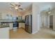 Charming kitchen featuring white cabinets, stainless steel appliances, and tile flooring at 5916 Nw 27Th Pl, Ocala, FL 34482
