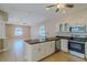 Open-concept kitchen with stainless appliances and breakfast bar at 5916 Nw 27Th Pl, Ocala, FL 34482