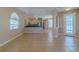 Open-concept living room with tile flooring leading to the kitchen and pool area at 5916 Nw 27Th Pl, Ocala, FL 34482