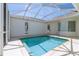 A screened-in pool features outdoor furniture, a blue sky, and access to the house at 5916 Nw 27Th Pl, Ocala, FL 34482