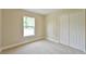 Carpeted bedroom featuring a window and closet at 6047 Sw 128Th Street Rd, Ocala, FL 34473