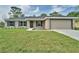 Attractive single-story home with green grass, and an attached garage at 6047 Sw 128Th Street Rd, Ocala, FL 34473