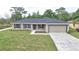 Charming single-story home with a well-manicured lawn and attached garage at 6047 Sw 128Th Street Rd, Ocala, FL 34473