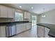 Open kitchen with stainless appliances, white cabinets, and a view of the backyard at 6047 Sw 128Th Street Rd, Ocala, FL 34473