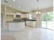 Spacious kitchen features a center island, granite countertops, and stainless steel appliances at 6047 Sw 128Th Street Rd, Ocala, FL 34473