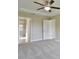 Carpeted main bedroom featuring ceiling fan and ensuite bathroom at 6047 Sw 128Th Street Rd, Ocala, FL 34473