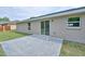 Backyard patio area with sliding glass door into the home on a sunny day at 6047 Sw 128Th Street Rd, Ocala, FL 34473