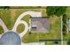 Stunning aerial view of a home featuring a circular driveway, large lawn, and outdoor patio area at 6125 Se 11Th St, Ocala, FL 34472