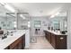 Bright bathroom featuring double vanity, a walk-in shower, and travertine tile flooring at 6125 Se 11Th St, Ocala, FL 34472