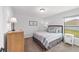 Cozy bedroom showcasing a comfortable bed, dresser, and serene window view at 6125 Se 11Th St, Ocala, FL 34472