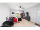 Spacious bedroom featuring an entertainment area, fan, and view of the outdoors at 6125 Se 11Th St, Ocala, FL 34472