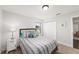 Bright bedroom with a striped comforter, complemented by coordinated pillows and a decorative nightstand at 6125 Se 11Th St, Ocala, FL 34472