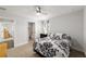 Comfortable bedroom with a patterned bedspread, ceiling fan, and ensuite bathroom access at 6125 Se 11Th St, Ocala, FL 34472