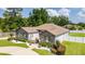 Landscaped front yard with circular driveway enhances curb appeal at 6125 Se 11Th St, Ocala, FL 34472