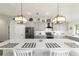 Bright, modern kitchen with gray cabinets, stainless steel appliances, and a large quartz countertop island at 6125 Se 11Th St, Ocala, FL 34472