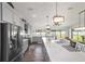 Gourmet kitchen with granite countertops, a large center island, and stainless steel appliances at 6125 Se 11Th St, Ocala, FL 34472
