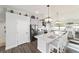 Bright kitchen featuring gray cabinets, a large quartz island with seating, and stainless steel appliances at 6125 Se 11Th St, Ocala, FL 34472