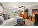 Main bedroom features a four-poster bed, a ceiling fan, a dresser and an ensuite bathroom at 6125 Se 11Th St, Ocala, FL 34472
