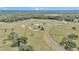 Expansive aerial view of the property showcasing its vast acreage, scattered trees, and luxurious homes at 7432 Ne 26Th Ave, Ocala, FL 34479