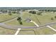 Expansive aerial view of a brick home situated on a sprawling green lawn with black fencing at 7432 Ne 26Th Ave, Ocala, FL 34479