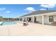 Large backyard with a pool, patio, and a covered seating area, perfect for outdoor fun at 7432 Ne 26Th Ave, Ocala, FL 34479