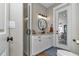 Bathroom featuring a walk-in shower, vanity with granite countertop and a mirror at 7432 Ne 26Th Ave, Ocala, FL 34479
