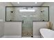 This new bathroom features a large shower with dual shower heads and stone flooring at 7432 Ne 26Th Ave, Ocala, FL 34479