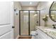 Modern bathroom featuring a tiled shower with glass door, granite counters, and a sink at 7432 Ne 26Th Ave, Ocala, FL 34479