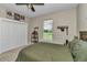 Neutral bedroom with a ceiling fan, closet, window with blinds, and Tampa Bay Buccaneers decor at 7432 Ne 26Th Ave, Ocala, FL 34479