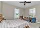 Bright bedroom with a comfortable bed, desk, chair, and lots of natural light at 7432 Ne 26Th Ave, Ocala, FL 34479
