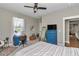 This bedroom has a desk, a television, a large dresser, and lots of natural light at 7432 Ne 26Th Ave, Ocala, FL 34479
