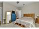 Bedroom with neutral walls, wood bed frame, and a view of the bathroom at 7432 Ne 26Th Ave, Ocala, FL 34479
