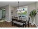 Charming dining area with wood table, bench seating, and backyard view at 7432 Ne 26Th Ave, Ocala, FL 34479