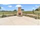 Outdoor brick fireplace with an unobstructed view of the large backyard at 7432 Ne 26Th Ave, Ocala, FL 34479