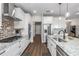 Modern kitchen features white cabinets, a large island, and stainless steel appliances at 7432 Ne 26Th Ave, Ocala, FL 34479