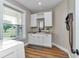 Convenient laundry room features white cabinets, granite counters, sink, and nice outside views at 7432 Ne 26Th Ave, Ocala, FL 34479
