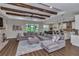 Open living area with exposed beams, brick accents, flowing into kitchen and dining spaces at 7432 Ne 26Th Ave, Ocala, FL 34479