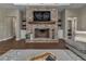 Inviting living room featuring a cozy fireplace with a brick surround and a wooden mantle at 7432 Ne 26Th Ave, Ocala, FL 34479