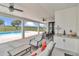 Relaxing covered patio with a sink, ceiling fans, a table, and a view of the pool and pasture at 7432 Ne 26Th Ave, Ocala, FL 34479