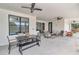 This covered patio offers multiple places to sit and relax, as well as a view of the pool at 7432 Ne 26Th Ave, Ocala, FL 34479