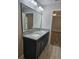 Bathroom showcases a double sink vanity with granite countertops, with a view into an adjacent room at 7677 Sw 81St Pl, Ocala, FL 34476